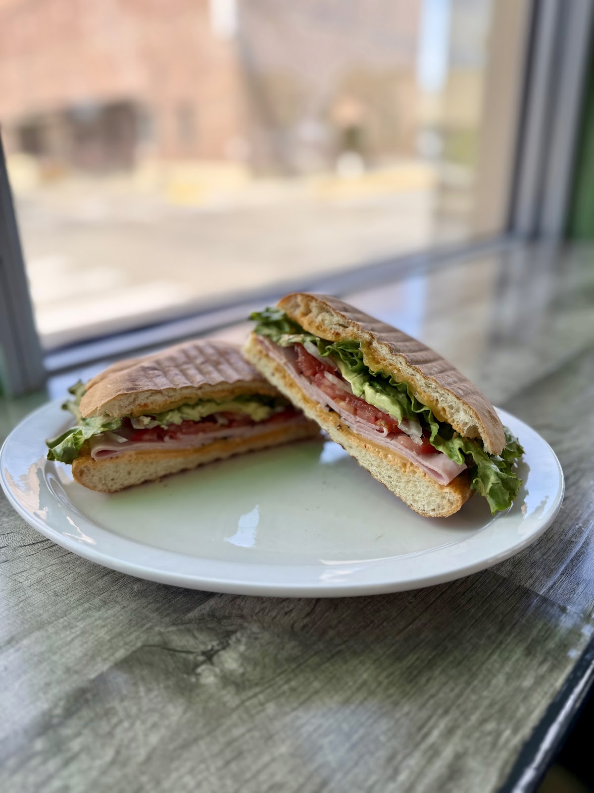 A pressed torta sliced and plated by the window