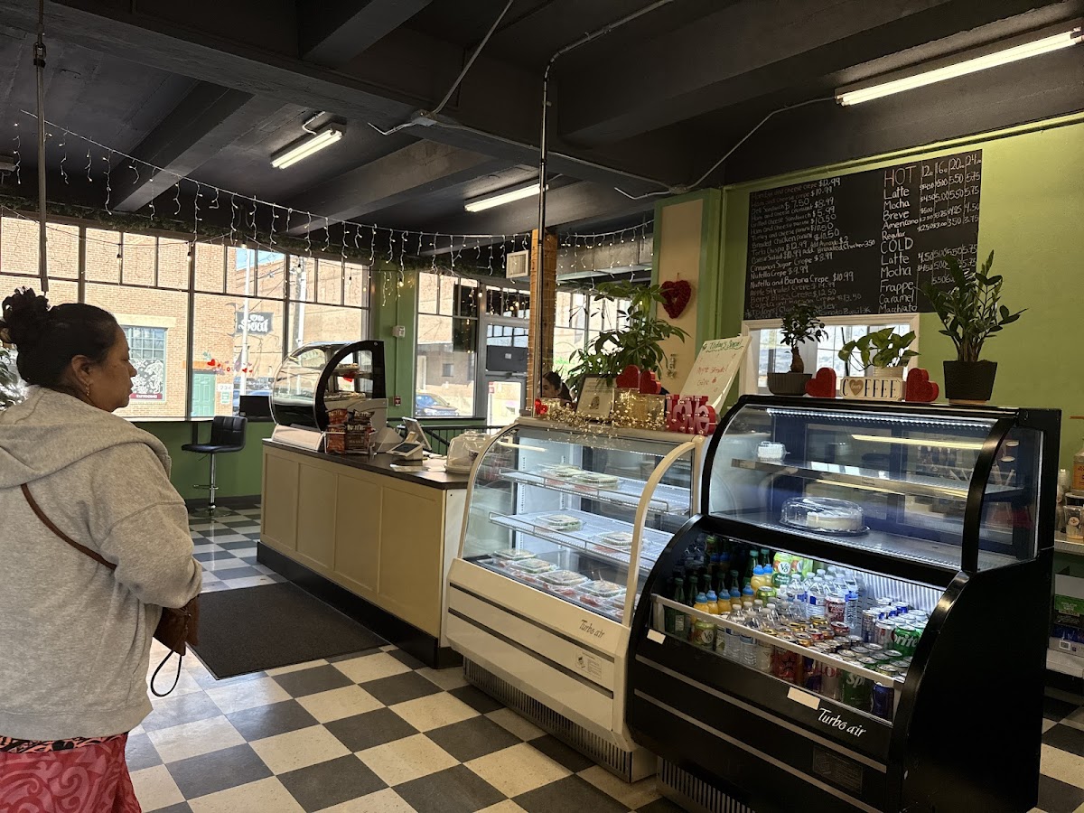 The counter and pastry cases under the chalkboard menu